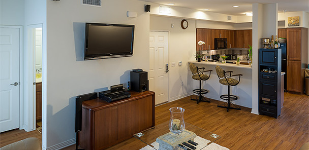 Unit interior showing living room with view into the kitchen. 